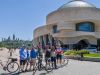 Tour participants taking a picture at the Museum of History lookout with Parliament view during Ottawa highlights bike tour