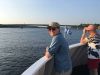 Boat cruise guest is looking at Ottawa River from the boat deck during bike & boat tour of Ottawa with Escape on Sparks