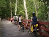 Group cycling at Voyageur bike trail from Ottawa to Aylmer and crossing a wooden bridge with Escape Tours Rentals on Sparks