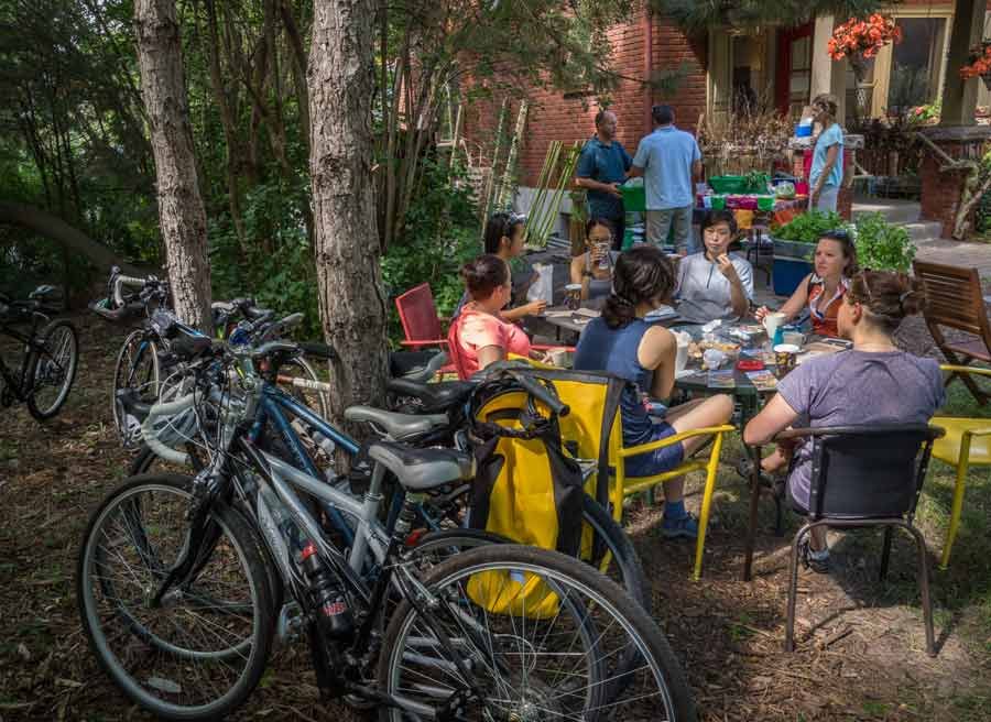 Guests sitting at a patio at a local cafe for lunch with bikes parked during day bike tour from Ottawa to Aylmer by Escape