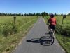 A guest is biking at the waterfront trail during Cornwall multi-day cycling tour by Escape tours rentals