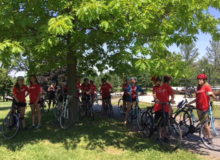 Youth group taking a student Ottawa bike tour with escape and biking at Rideau Canal and stop at Hartwells Locks for sightseeing