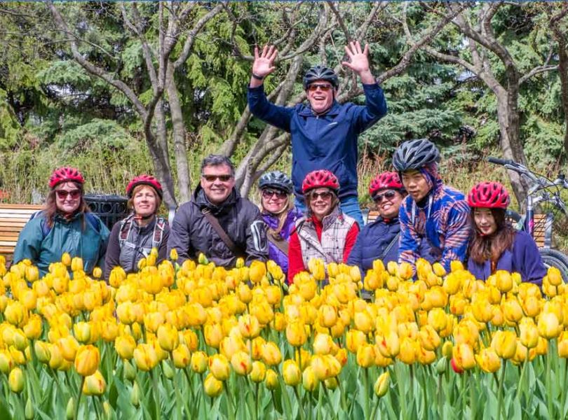 Family and friends are happily visiting the Tulip festival at Commissioners park, Dow’s Lake during Escape Tulip bike tour in Ottawa in May