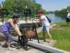 Tour participants are playing with Rideau Canal lock crank at Rideau Canal pathway during Ottawa highlights tour by bike 