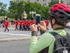 A guest is watching and taking a picture of the change of guard ceremony on Elgin st. during Ottawa highlights bike tour 