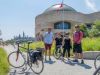 Tour participants taking a picture at History Museum lookout with Parliament view during Ottawa multi-day bike tour by Escape