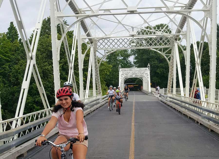 Tour participants are happily cycling on Minto bridge in new Edinburgh neighbourhood during Ottawa highlights bike tour 