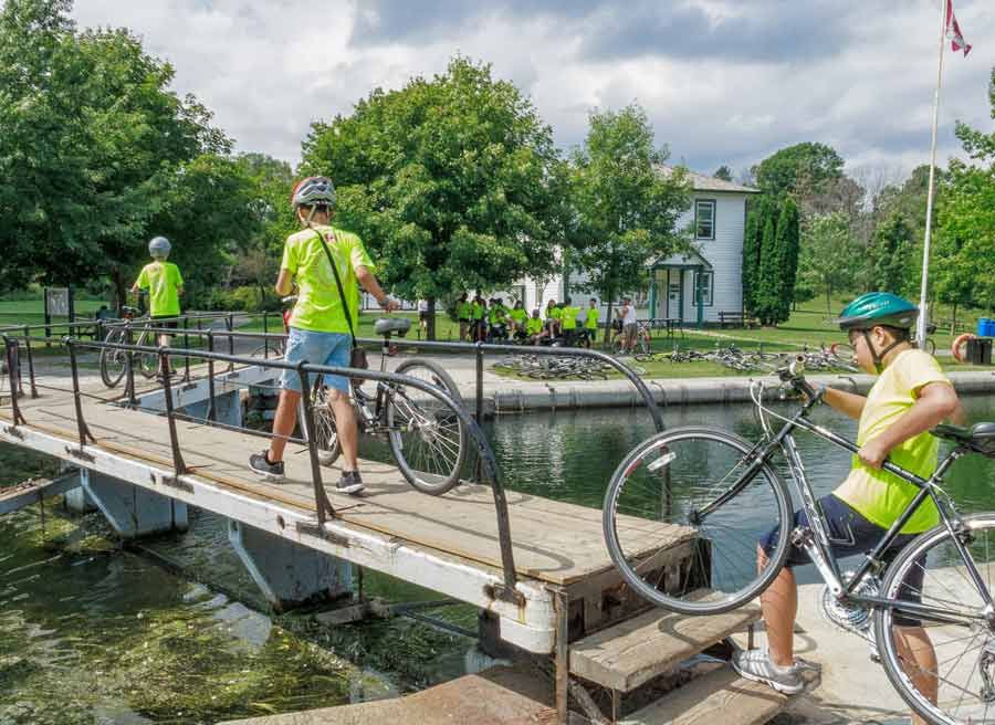 Youth are crossing Hartwells Lock at Rideau Canal during their  school bike tour in Ottawa with Escape tours rentals