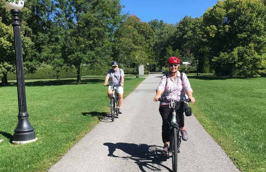 Couple are cycling with electric bikes on Ottawa bike trails during their Ottawa tour by bike with Escape Tours and Rentals