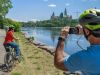 Guests have stopped at bike trail to take picture of Ottawa River and Parliament Building during Ottawa highlights bike tour 