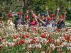 Happy participants are waving hands at Tulip festival at Dow’s Lake during Escape Ottawa Tulip bike tour in May