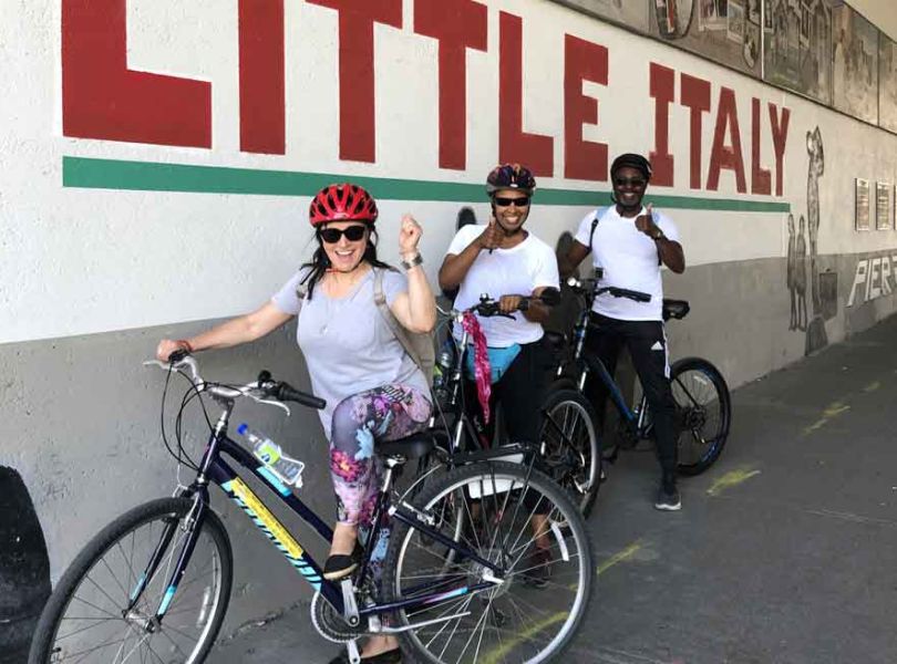Small group visiting Little Italy neighbourhood during Escape best of Ottawa neighbourhood and nature bike tour 