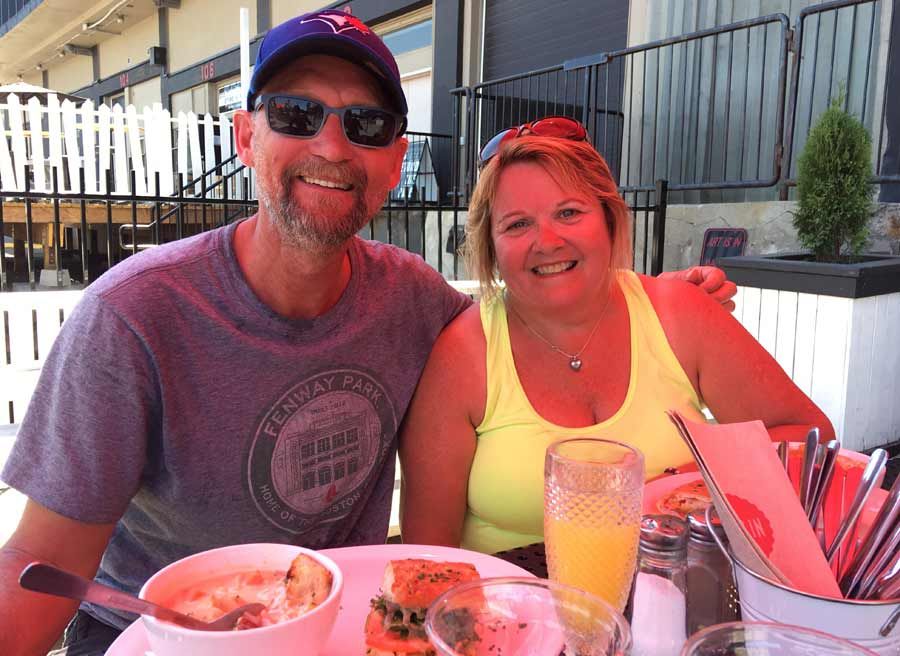Couple celebrating anniversary with a private bike and food tour and stop for lunch and craft bear with Escape Tours Rentals