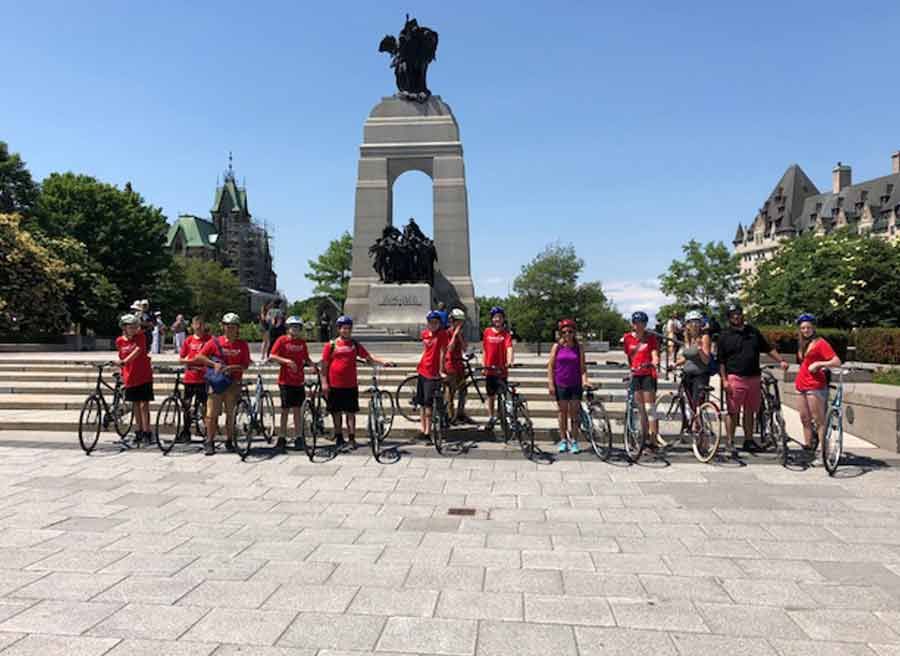 School group biking through War Memorial during Ottawa their bike tour with Escape tours rentals