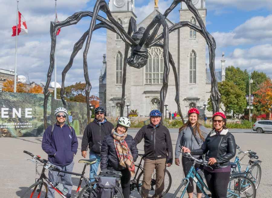 Guests taking picture in front of Spider Maman, Notre-Dame Cathedral Basilica during Escape Ottawa multi-day cycling tour