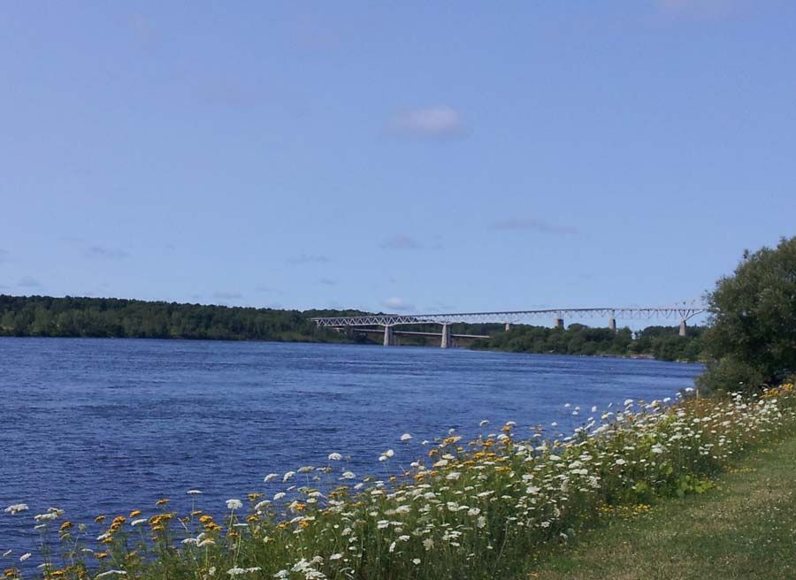 View of St. Lawrence River & bridge at Cornwall when biking on waterfront trail during Cornwall day tour by bike with Escape