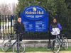 Tour guide is taking  a picture of a couple in front of Rideau Hall during Ottawa express guided bike tour with Escape