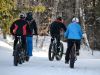 A group is enjoying riding fat bikes during a winter fat bike tour by Escape tours and rentals in Ottawa