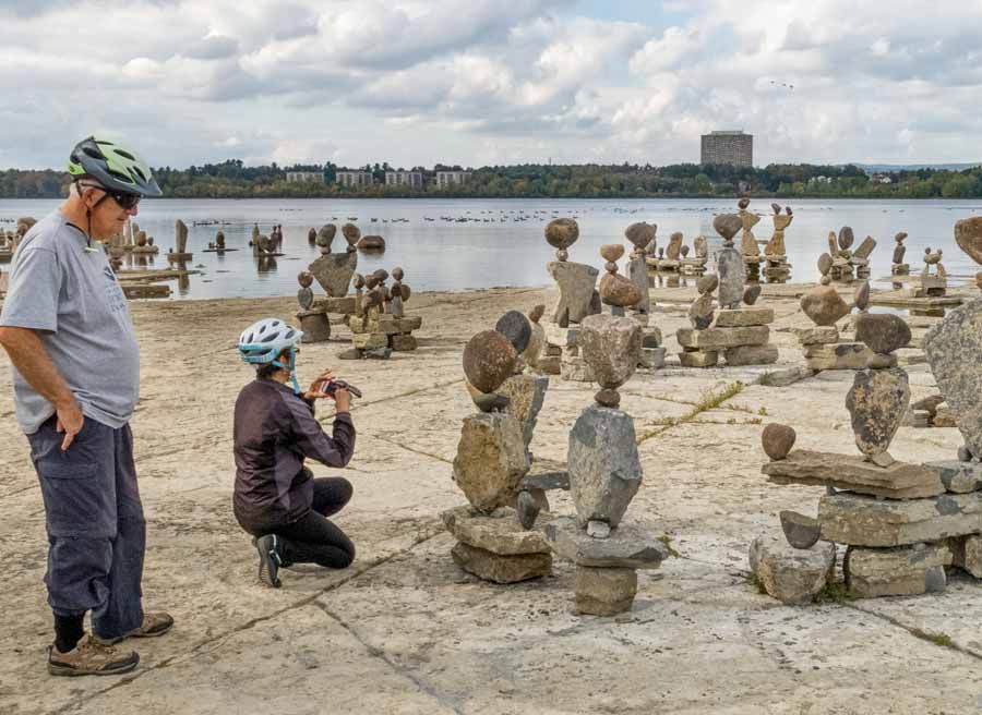 Participants visit Remic Rapids and take picture of rock sculptures during Ottawa multi-day cycling tour by Escape on Sparks