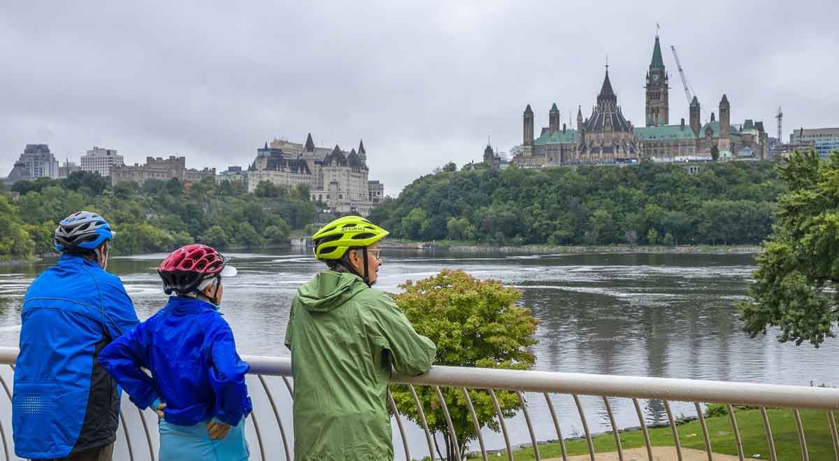 Guests enjoy the parliament building view form the Museum of History look out during their Escape Ottawa bike tour