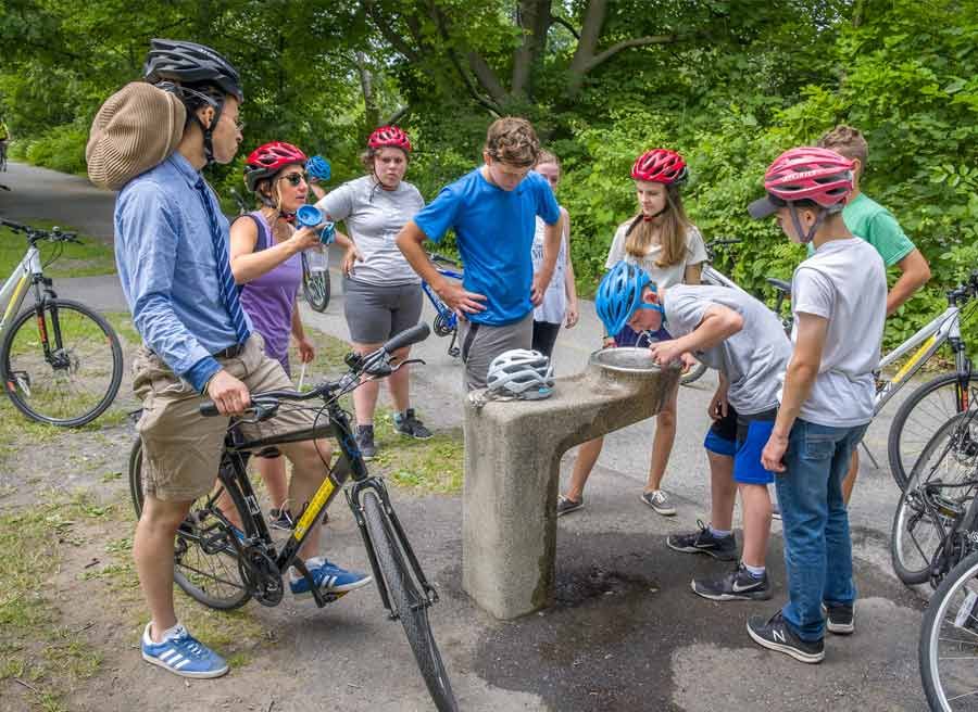 Students stop for water break during their school group bike tour at Rideau Canal with Escape tours rentals