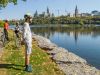 Guests have stopped at bike trail to take picture of Ottawa River and Parliament Building during Best of Ottawa bike tour