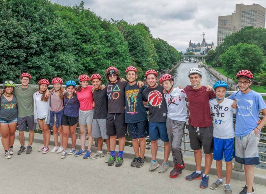 Student group is taking a bike tour at Rideau Canal landmark with Escape and stopping at Corktown Footbridge to take a picture