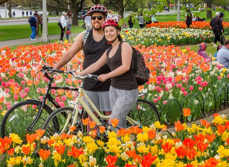 Couple enjoying a special tulip bike tour in Ottawa with Escape tours rentals at Dow's Lake landmark