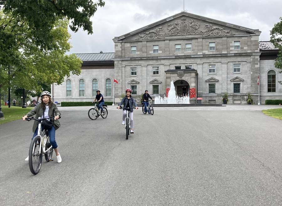 A family has joined Ottawa Electric Bike Tour with Escape in Ottawa and are biking at Rideau Hall in Ottawa