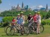 A corporate group taking a private Ottawa express bike tour and stop at Ottawa River path to see the view of the parliament