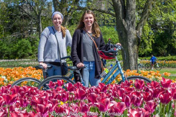 Women with bikes at Ottawa Tulip festivals during their Ottawa bike tour