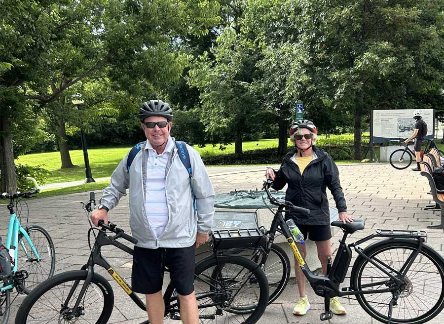 A couple is enjoying private electric bike Tour in Ottawa with Escape. A stop at Rideau Hall in Ottawa