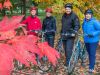 Guests looking at red Fall colours and taking pictures in Ottawa park during Ottawa highlights bike tour by Escape 