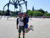 A couple is happy visiting Maman Sculpture landmark at the National Art Gallery during a private Ottawa express bike tour with Escape