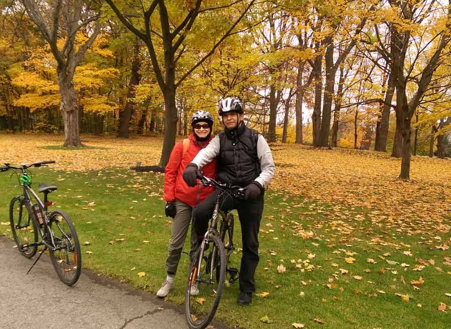 Tour guide taking a picture of guests with Fall colours when cycling from Rockcliffe to Petrie with Escape Ottawa day tour