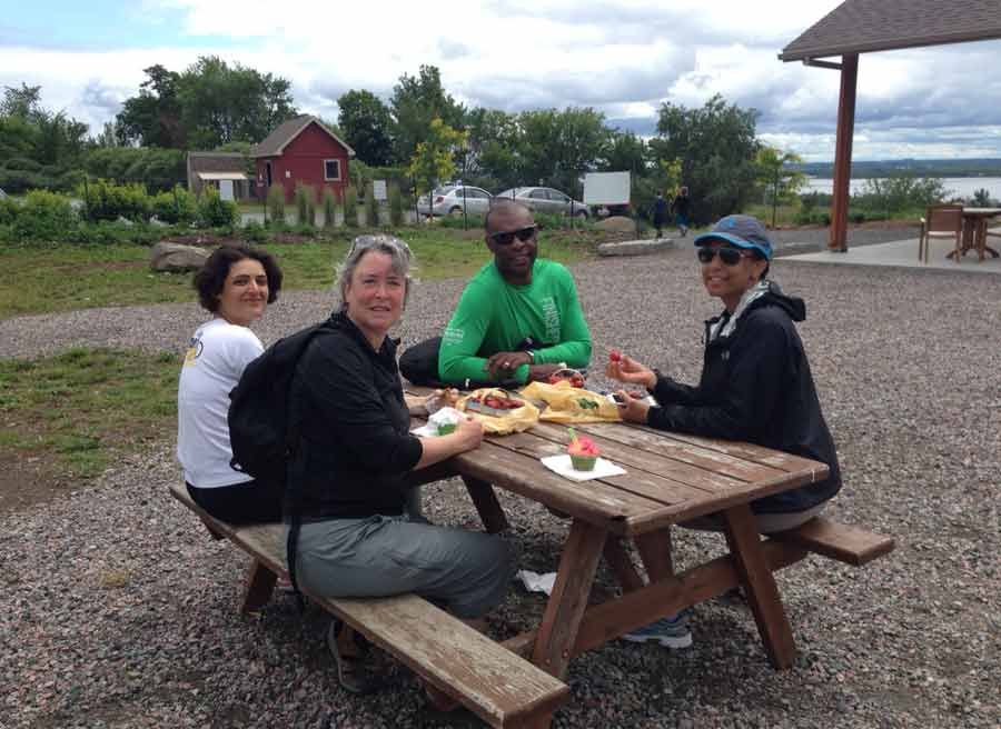 Guests are enjoying a picnic lunch at Petrie island during during Ottawa day tour by bike with Escape tours rentals
