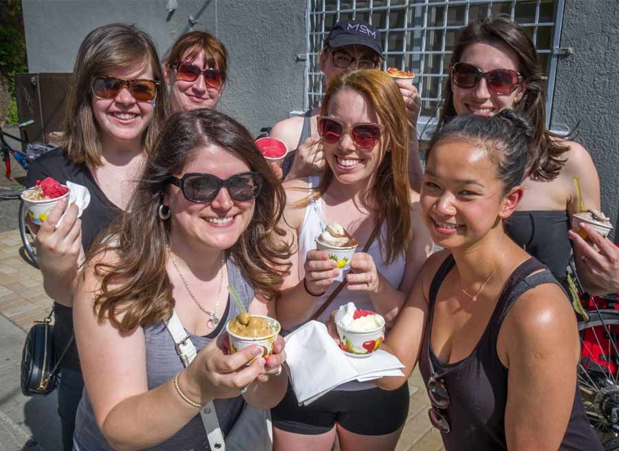A group of girlfriends having a bachelorette party eating artisan ice cream during Escape bike and food tour in Ottawa