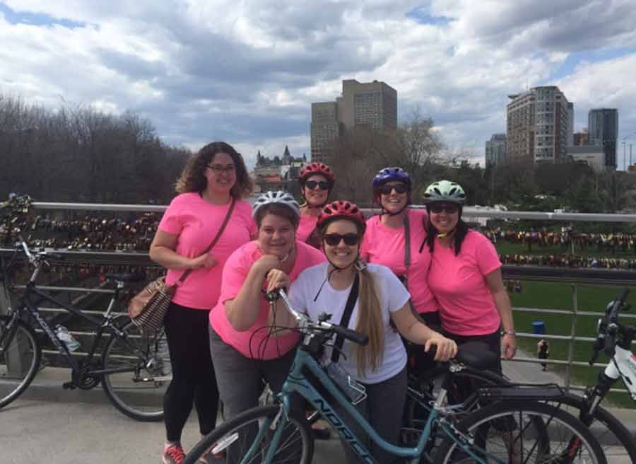 Friends are celebrating a bachelorette party with a private bike tour at Love Lock bridge Rideau Canal landmark with Escape bike tours rentals