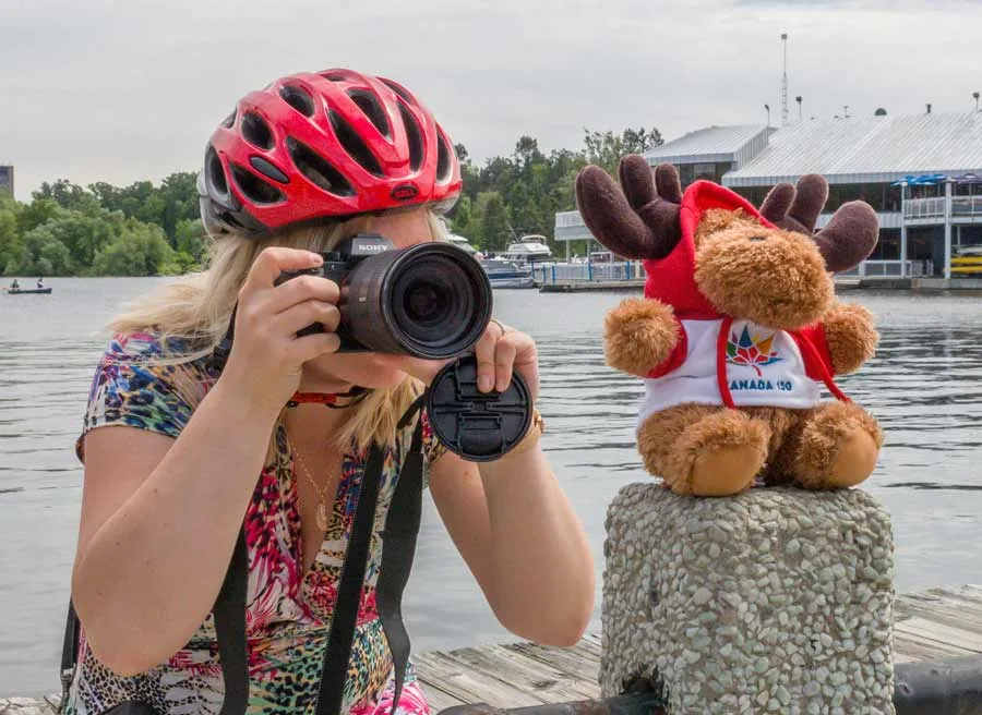 A guest is taking a picture at Dow’s Lake during a private best of Ottawa day tour by bike in Ottawa by Escape on Sparks