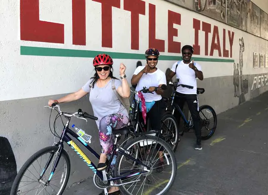 Small group visiting Little Italy neighbourhood during Escape best of Ottawa neighbourhood and nature bike tour