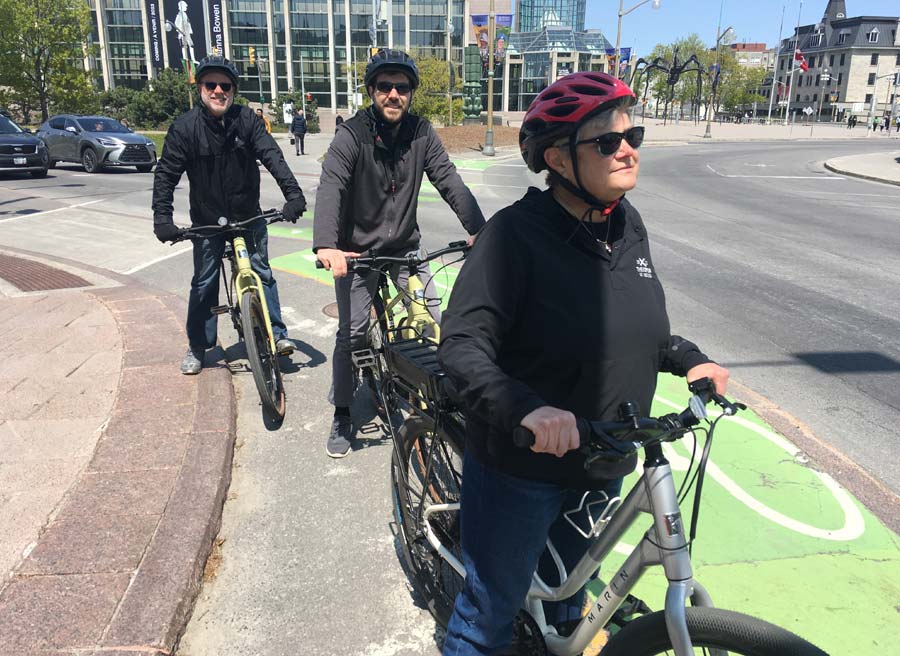 A family has joined Ottawa Electric Bike Tour with Escape in Ottawa and are biking on safe bike paths in Ottawa