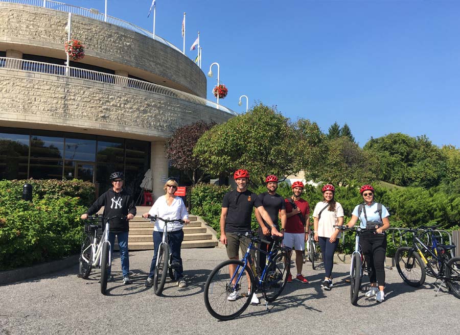 A family has joined Ottawa Electric Bike Tour with Escape in Ottawa and have stopped at the Canadian Museum of History for sightseeing
