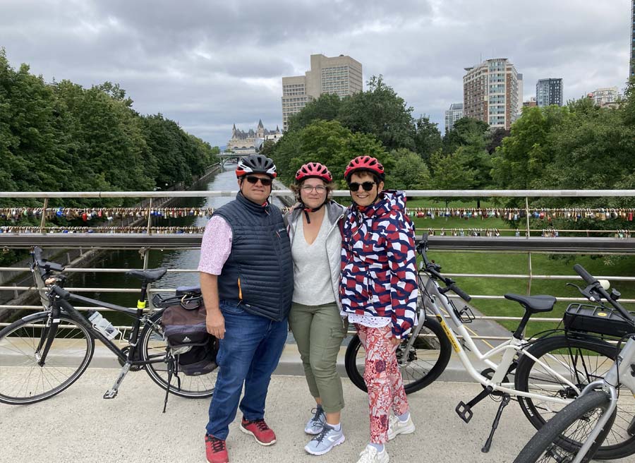 A group is enjoying a stop at Corktown Bridge on Rideau Canal during their Ottawa Electric Bike Tour with Escape.