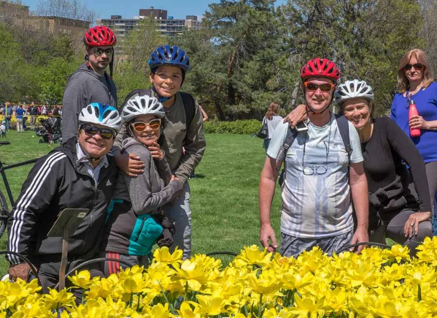 Small-group tour guests are happily visiting the Tulip festival at Commissioners park during Escape Ottawa Tulip bike tour