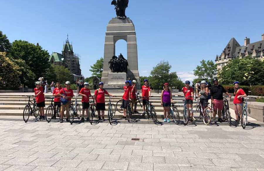 School group biking through War Memorial during Ottawa their bike tour with Escape tours rentals