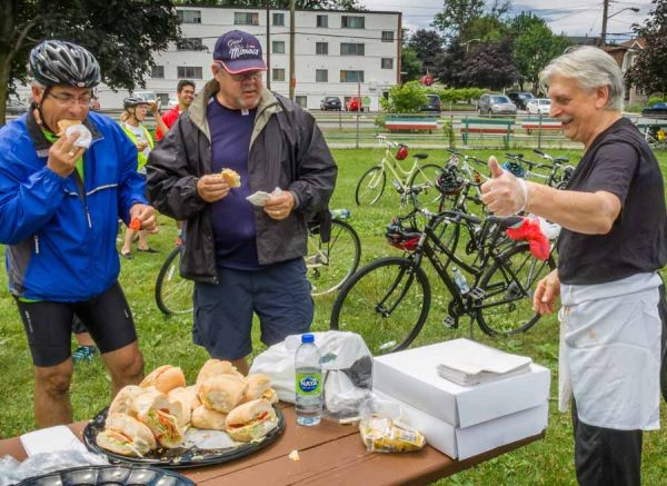 Corporate group is having picnic and eating locally made sandwiches at Little Italy during Escape private bike and food tour