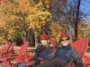 A couple is relaxing at adirondack chairs in a park during their bike and spa tour in ottawa with Escape tours and rentals 