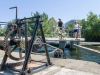 Guests are crossing Rideau Canal lock with their bikes during during best of Ottawa Neighbourhood and nature bike tour 