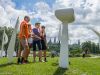 Guests are looking at and learning about art sculptures in front of Museum of History during Ottawa highlights bike tour