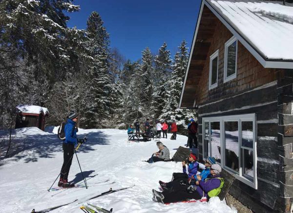 Healey hut with skiers outside